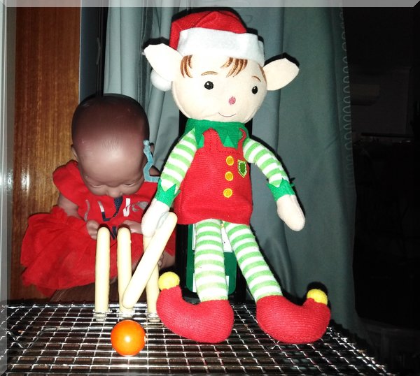 Christmas elf batting at cricket