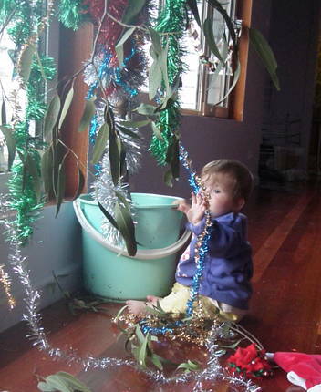 Baby playing with Christmas Gumtree tinsel