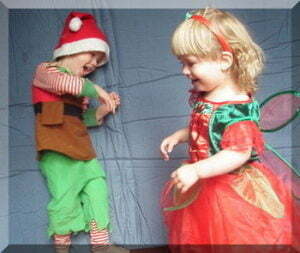 Happy children dancing in Christmas costumes