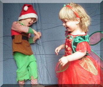 | love santa Two children dancing whilst dressed as an elf and a Christmas fiary