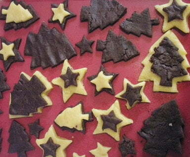 uncooked star and tree shaped biscuits on a tray