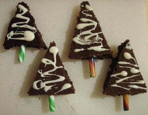 Christmas tree shaped cakes with candy cane trunks