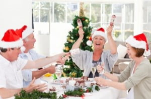 Family celebrating Christmas together with a meal and bon bons