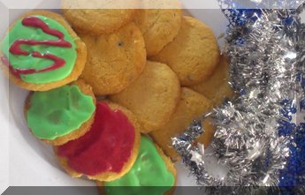 Passionfruit Christmas biscuits on a plate with tinsel