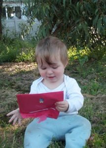 baby girl holding a red envelope