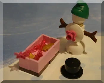SNowman wearing elf hat near wands and crowns