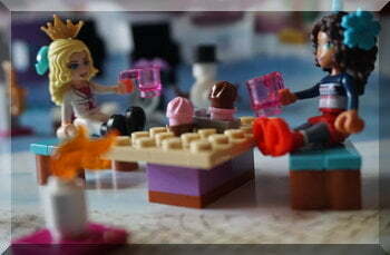 Lego girls sitting at a table