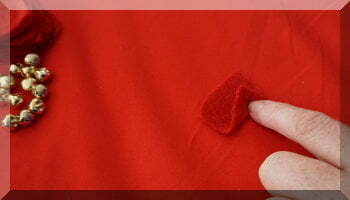 | love santa fingers folding red felt to make a petal