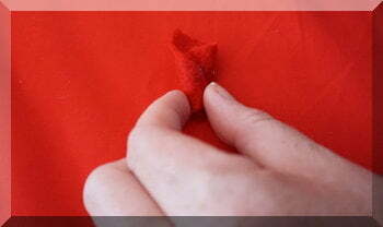 | love santa fingers holding red felt petal