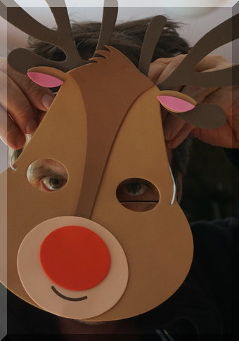 A close up on the reindeer mask over a face