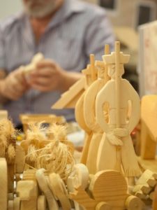 art of carving in wood with a carver working on the background