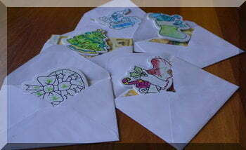 child-made decorations in Christmas card envelopes