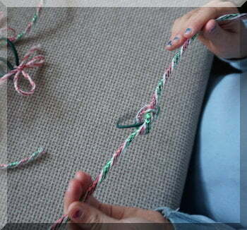 | love santa child tying string onto a hair tie