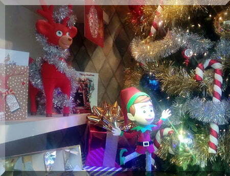 Elf dn reindeer beside their Christmas tree