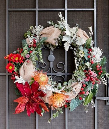 Red, orange and beige Christmas wreath on a door