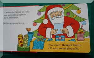 Inside page of Dear Santa book - Santa is reading a letter in front of a Christmas tree