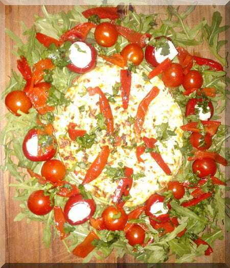 Baked cheese Christmas wreath on a wooden board