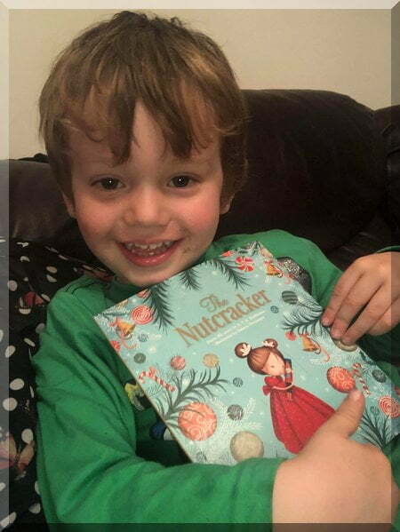 Smiling boy holding the Nutcracker book