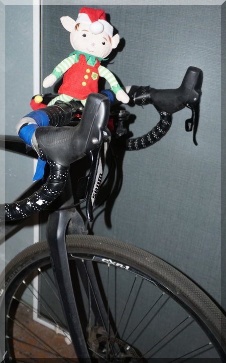 Tinkles the elf sitting on a full size bike