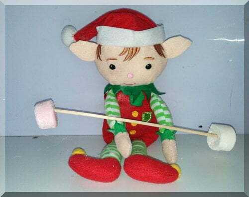 Christmas elf lifting marshmallows on a stick as weights