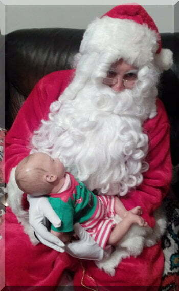 Santa with a baby dressed as an elf