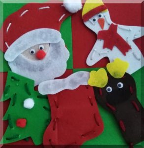five felt Christmas finger puppets on a red and green background