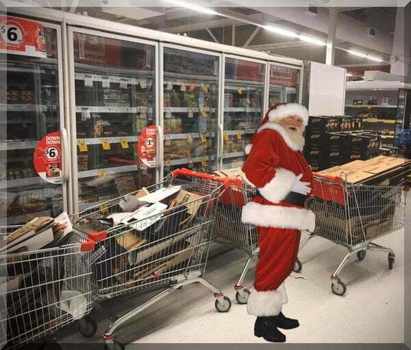 Santa with supermarket trolleys of boxes