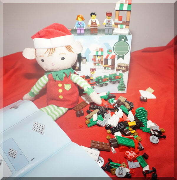 Tinkles the elf with Lego instructions and pieces