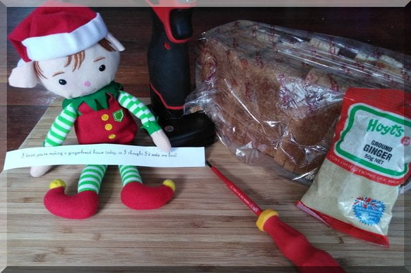 Christmas elf preparing to build a gingerbread house