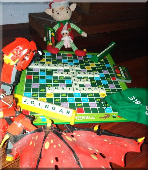 | love santa Lego Dragon and Christmas elf made Christmas words on the scrabble board