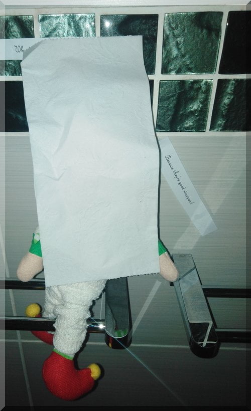 Tinkles the Christmas Elf wrapped as a mummy, eyes covered