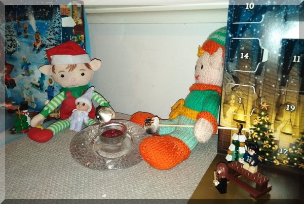 Christmas and Tooth Elves toasting marshmallow on a Christmas candle