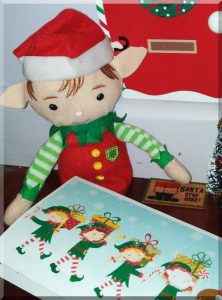 | love santa Tinkles sitting beside a doormat printed with 'Santa stop here!'