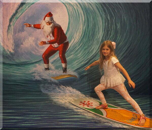 | love santa Santa and a girl on surf boards in a wave tunnel