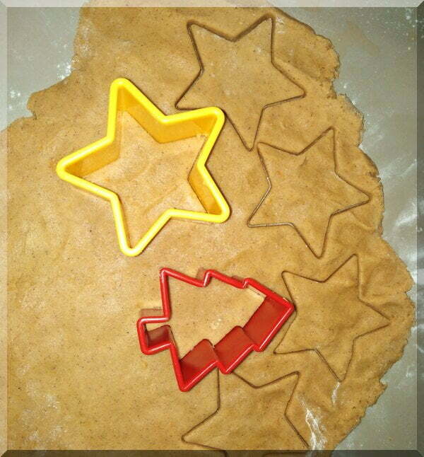 Pepparkakor dough being cut into Christmas shapes