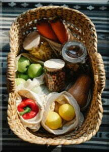 woven basket of fresh vegetables and jars of preserves