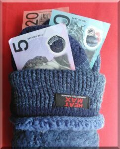 Australian notes tucked into the folds of a pair of blue hiking socks