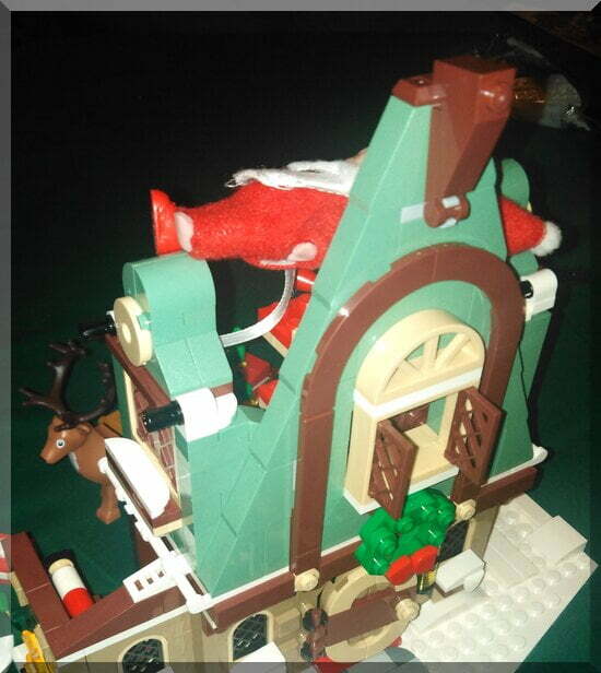 front of a Lego chalet with baby elf legs popping out