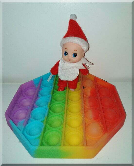 Ginger-poppit_550 | love santa Baby elf standing on a rainbow poppit toy