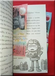Australian $20 note in the pages of a book with an elf picture