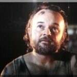 A man's face as he stares at the moon in the movie Sunburnt Christmas