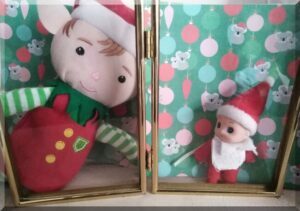 Two CHristmas elves in a photo frame with an Australian themed Christmas background