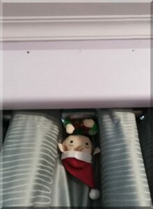 Tinkles-hanging-curtain-600 | love santa Christmas elf hanging upside down from a curtain rail