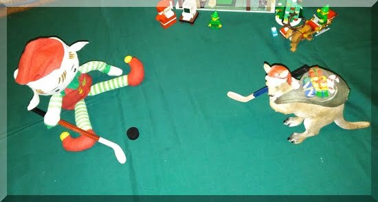 Christmas elf and kangaroo playing a game of hockey