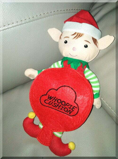 Christmas elf wearing a red costume that looks like a whoopie cushion