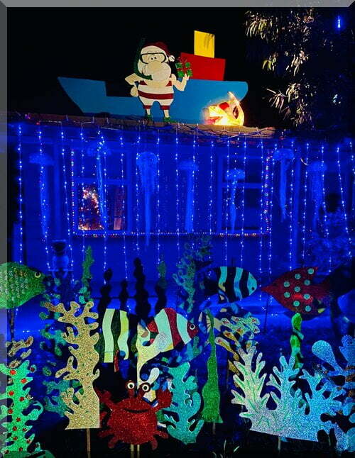 A summery Santa and boat above a blue reef with fish - Christmas display