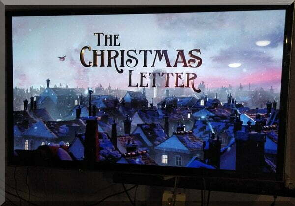 title screen for The Christmas Letter showing the rooves of a town