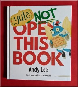 Front cover of the book Yule NOT open this book by Andy Lee, showing the title and blue creature holding a letter to Santa