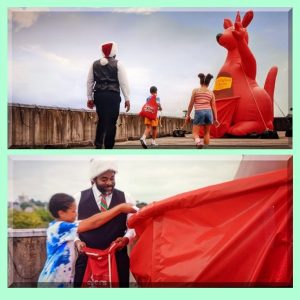 Pair of photos showing a very large inflatable kangaroo with a man and two children putting Santa letters into her pouch