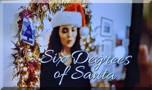 Title screen of movie Six Degrees of Santa showing a woman in a Santa hat
